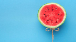 sliced watermelon placed against a blue background