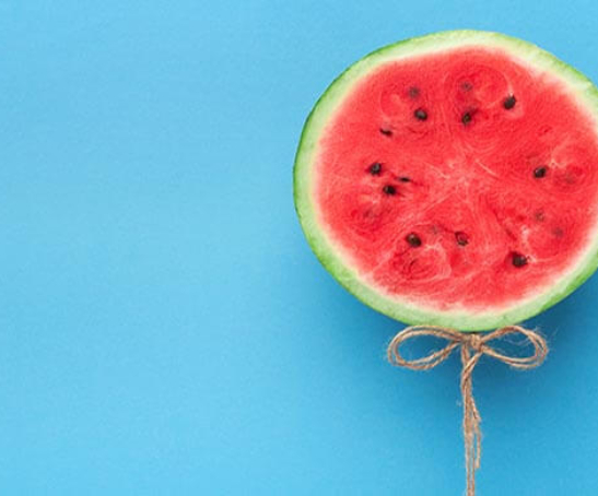 sliced watermelon placed against a blue background