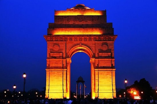 India Gate monument illuminated at night in New Delhi, India